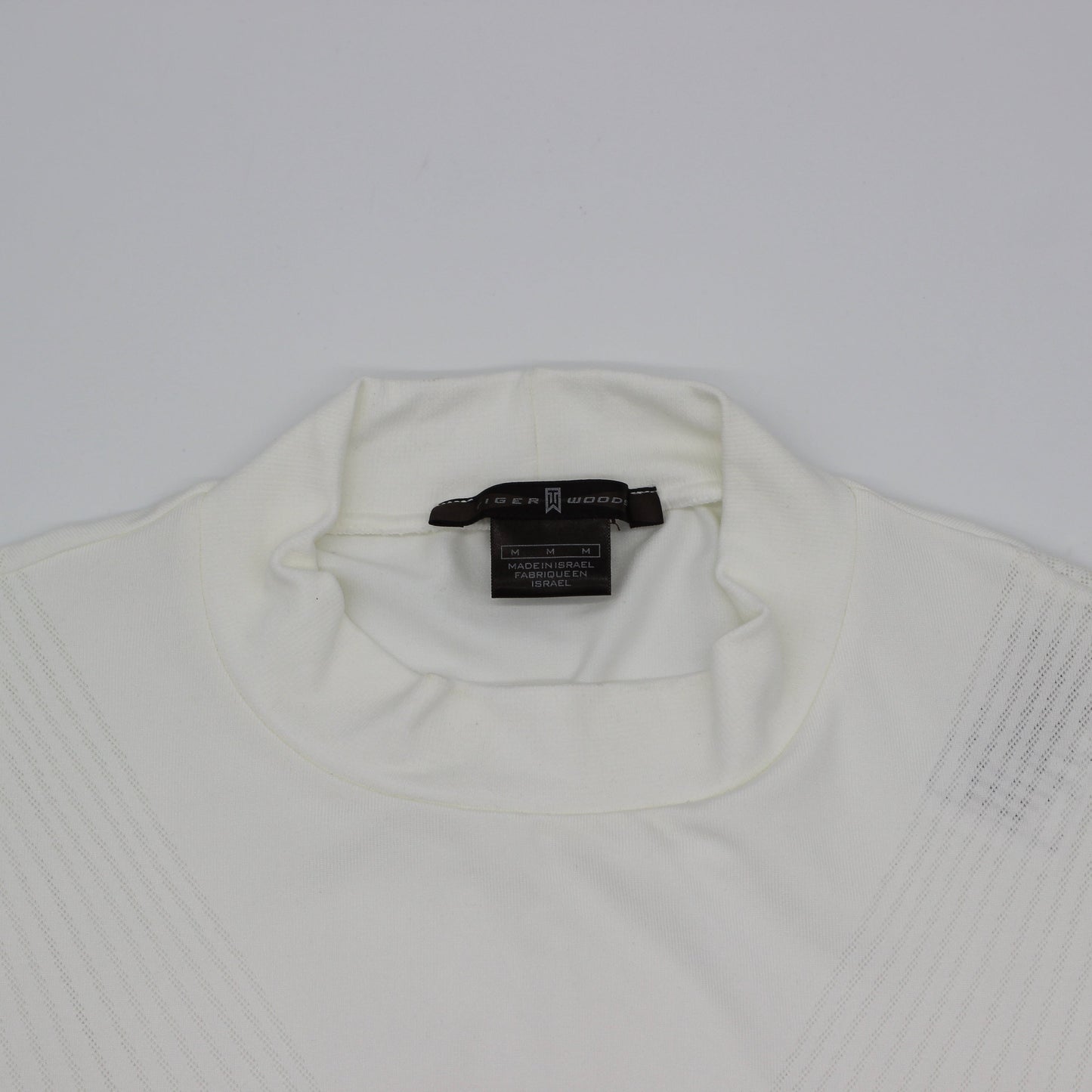 White Tiger Woods Mock Neck with a tag on a light gray background
