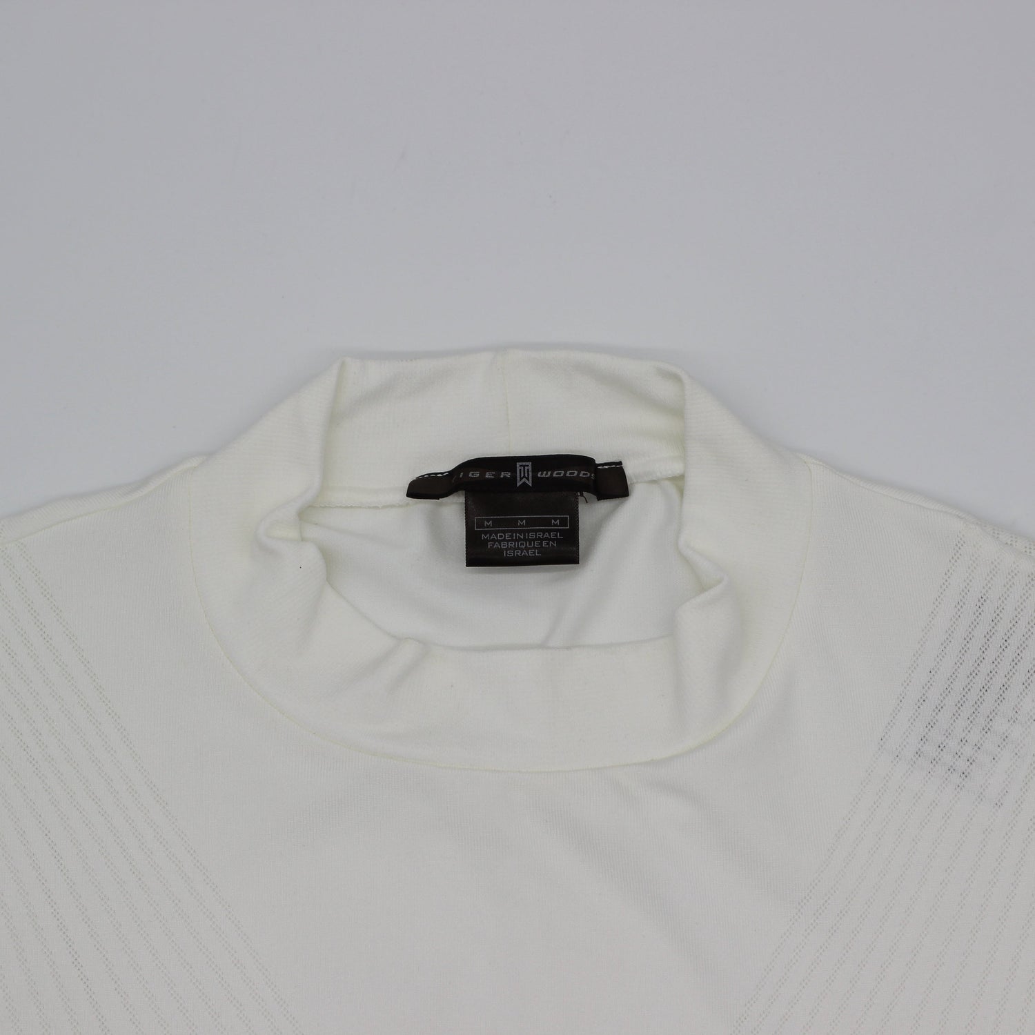 White Tiger Woods Mock Neck with a tag on a light gray background