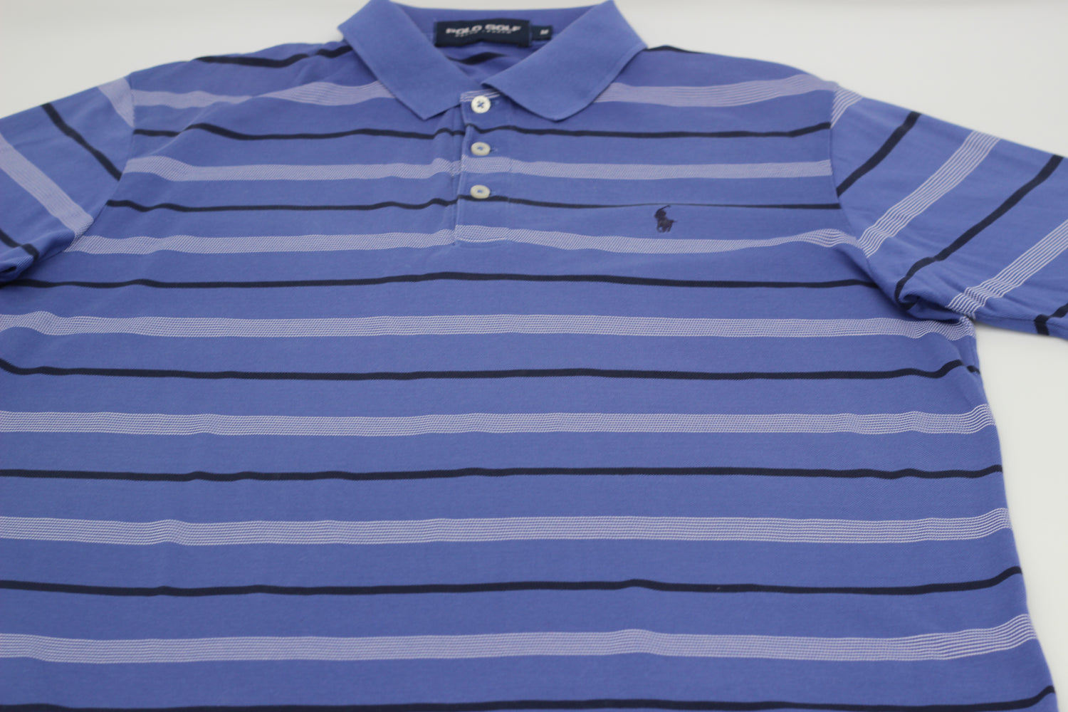 A Polo Ralph Lauren blue golf polo shirt in size medium, featuring a classic collar, short sleeves, and the brand's iconic polo player logo embroidered on the chest